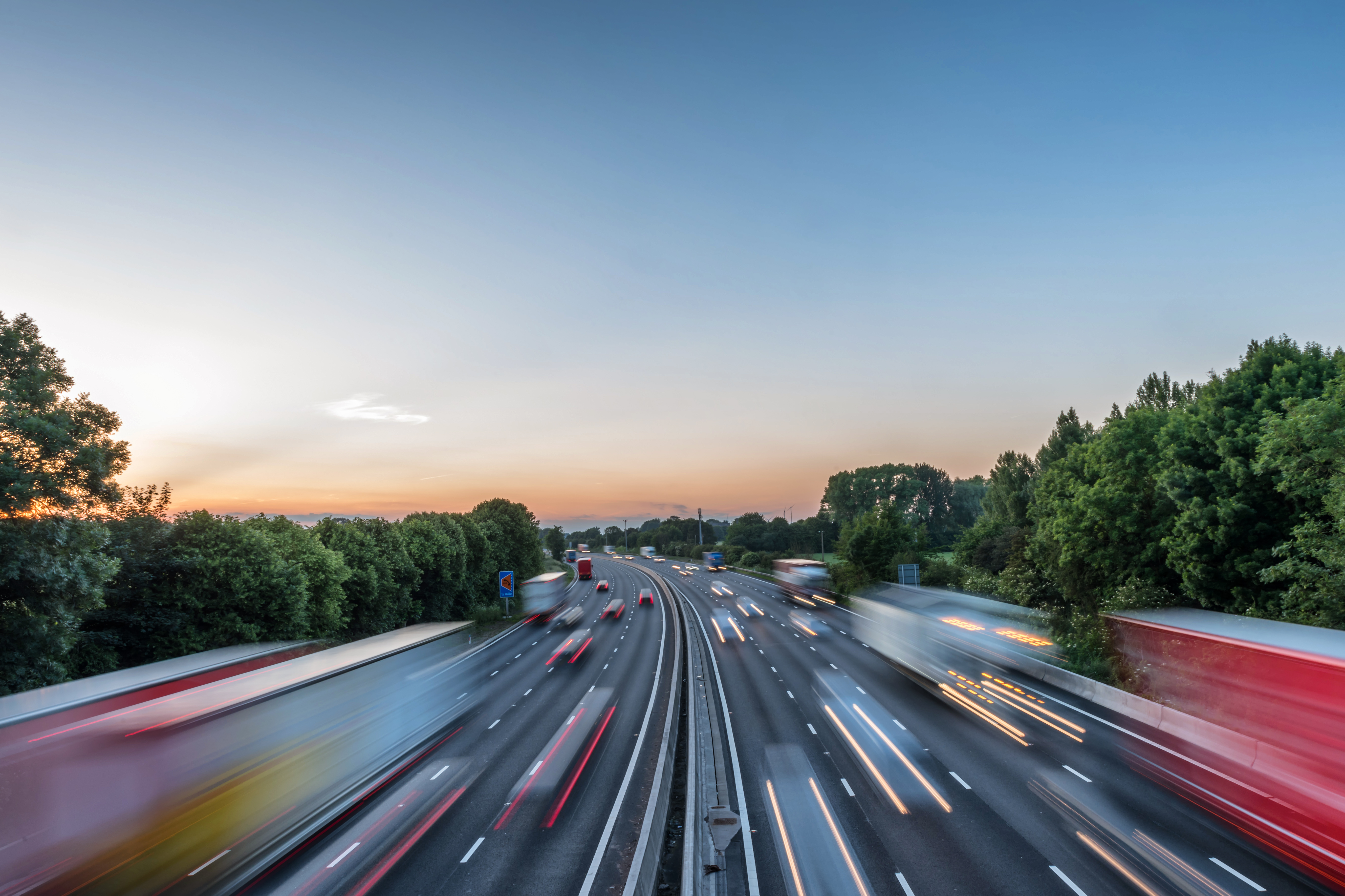 sunset view heavy traffic moving at speed on uk motorway in england